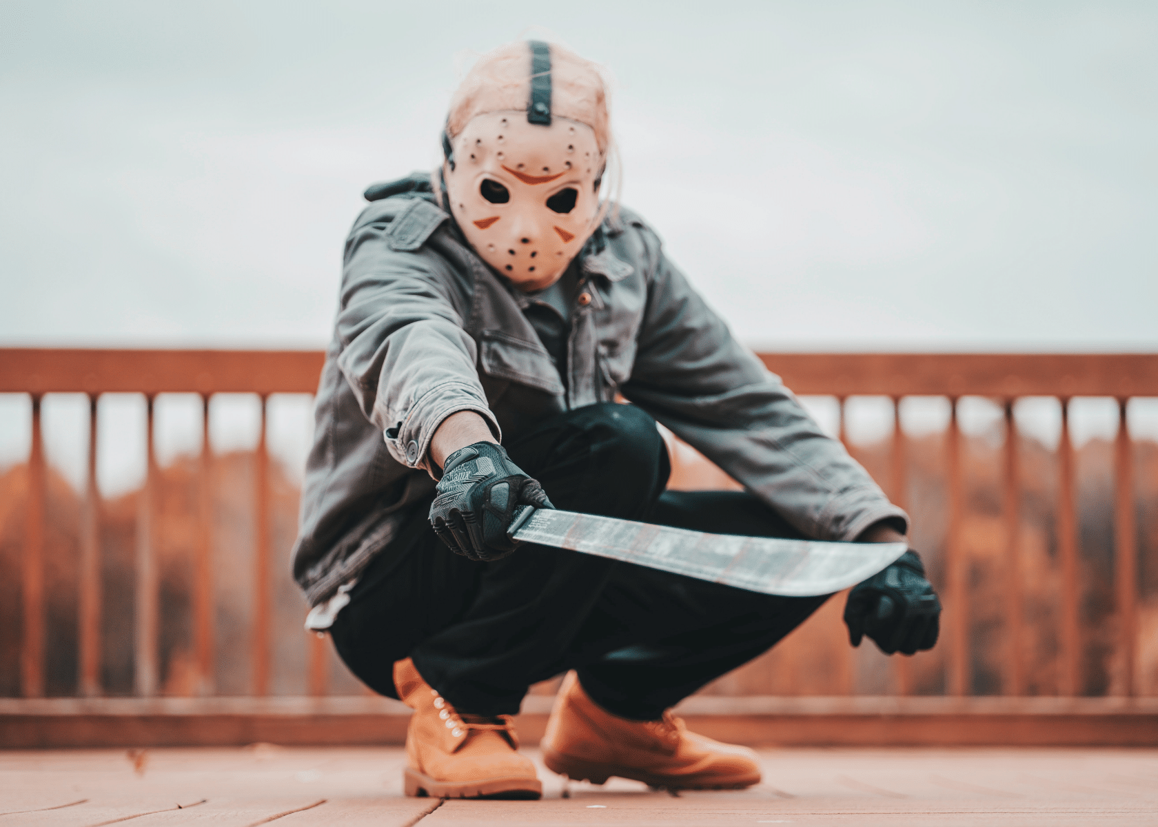 A man in a hockey mask holding a machete looking like he's starring in a horror movie