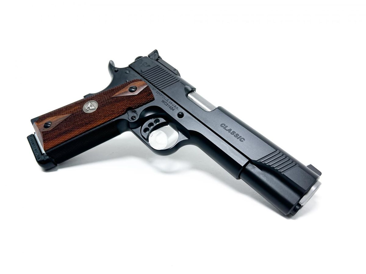 A 1911 shown with wood grips