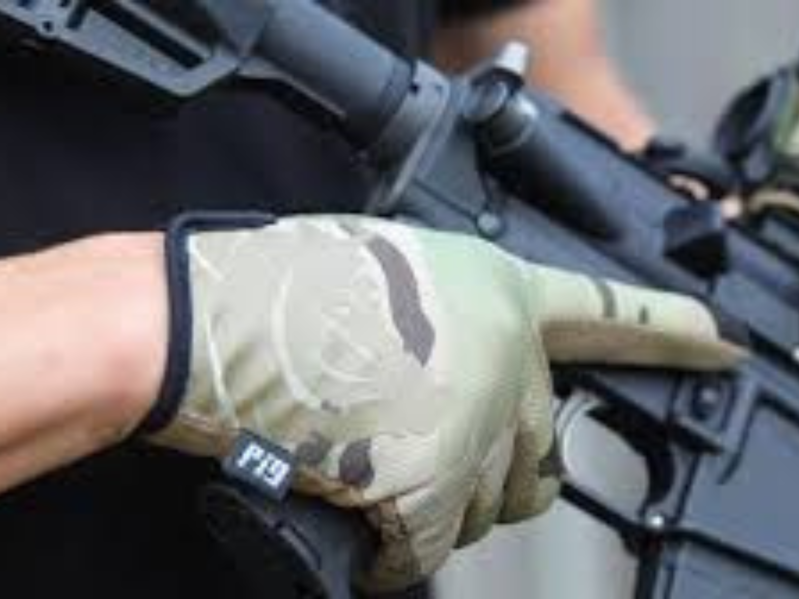 A man wearing PIG tactical gloves holding an AR15.