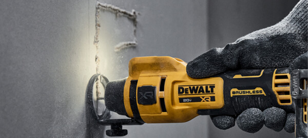 A cut out tool cutting a hole in a wall.
