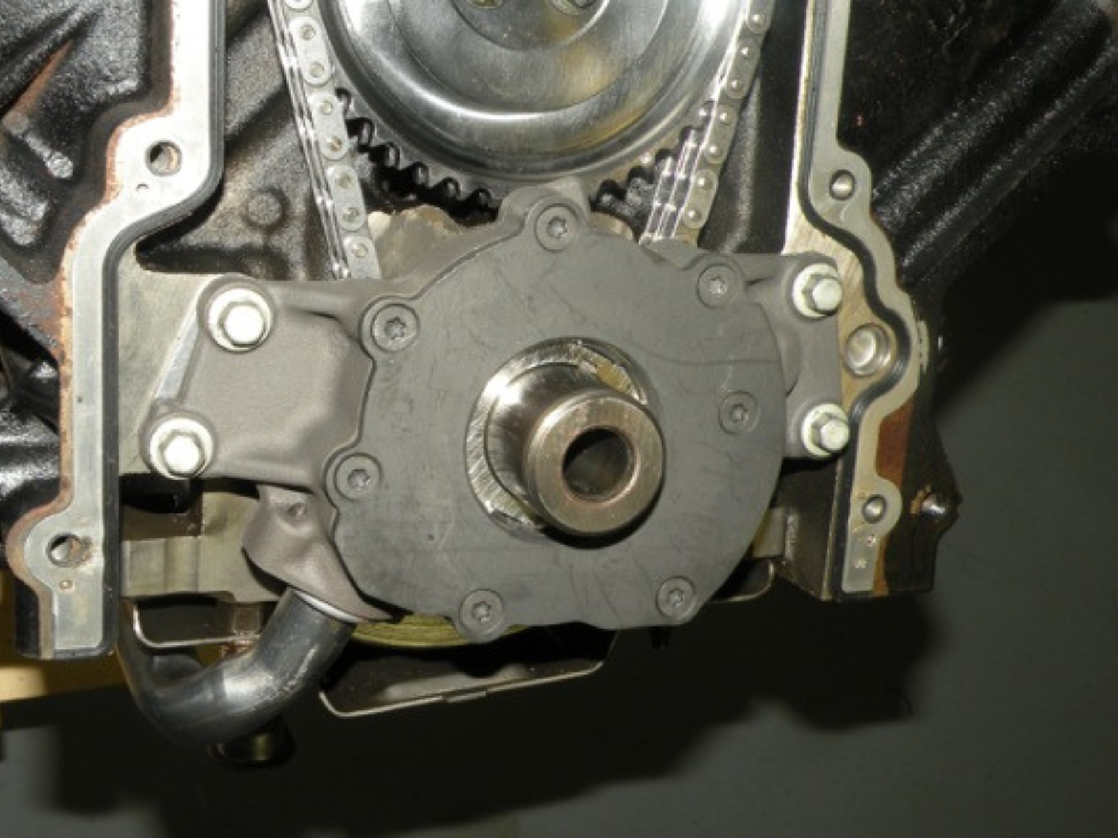 The timing cover and oil pan removed from a LS engine to expose the oil pump.