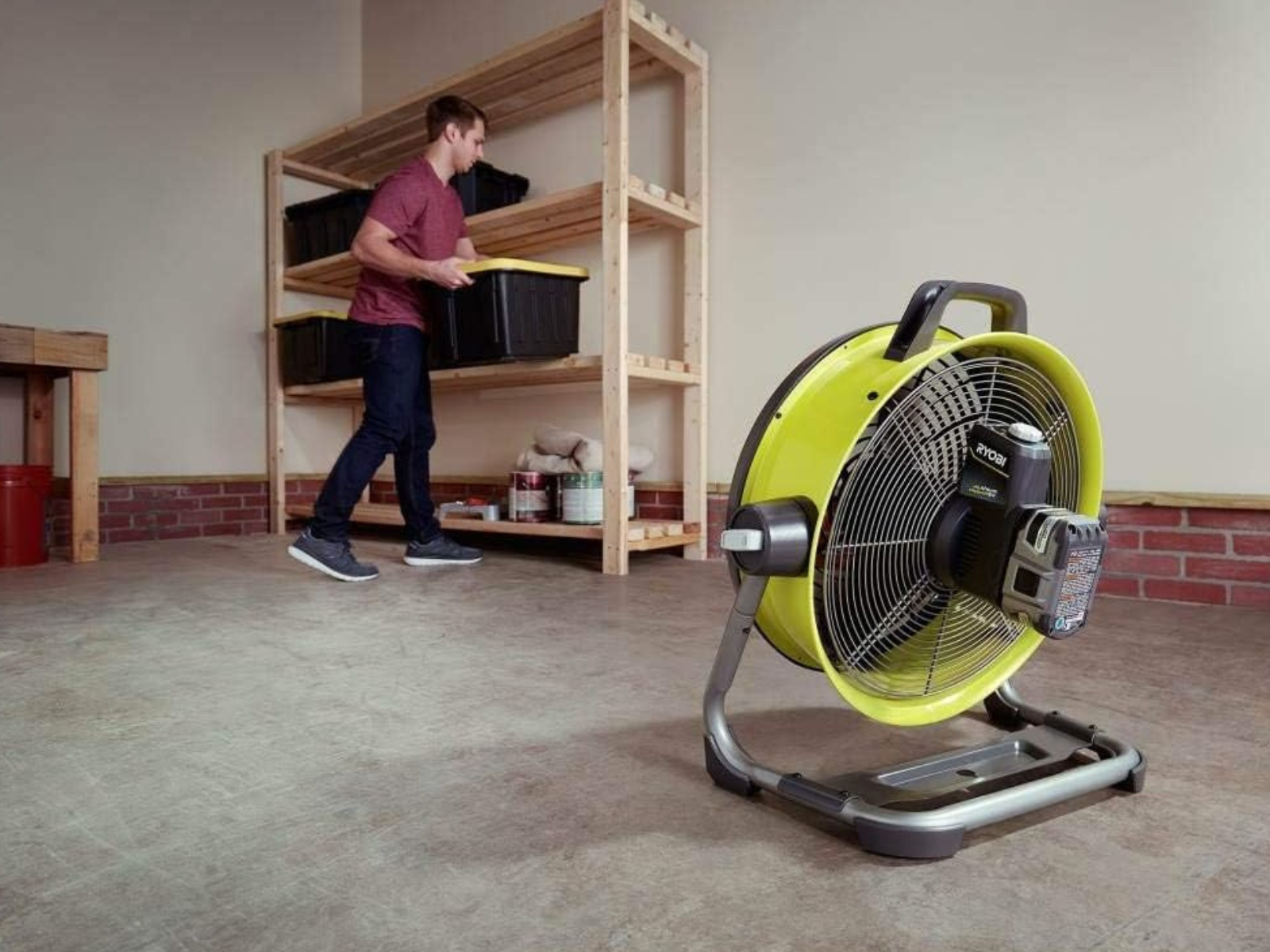 A cordless One+ fan cooling off the garage for a man working with Ryobi.