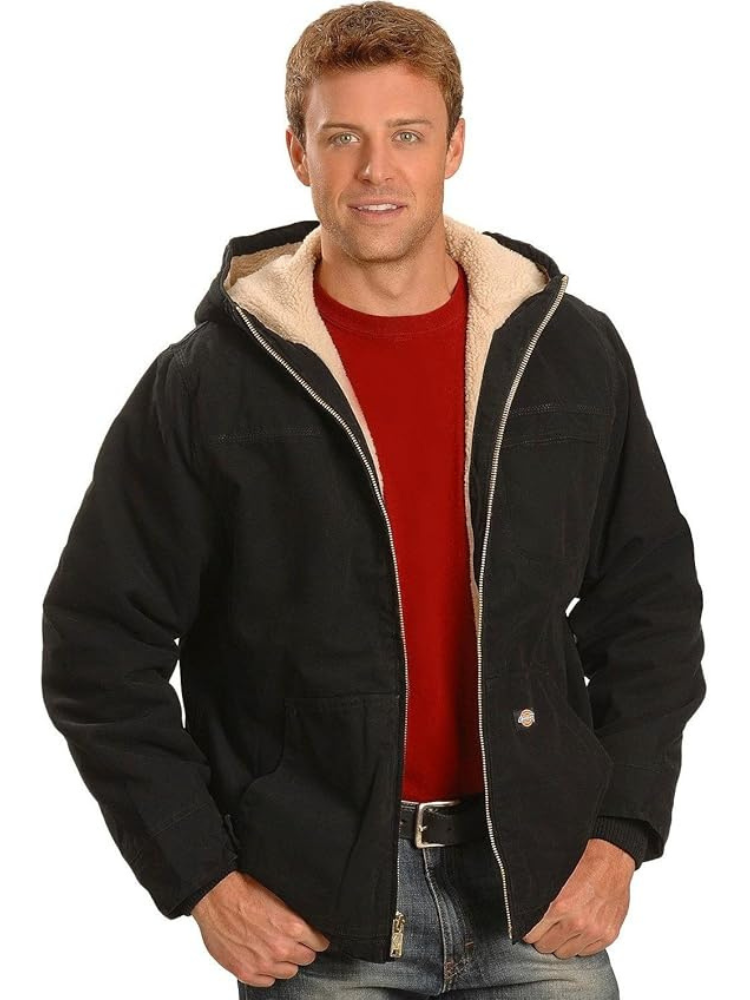 A man wearing a Dickies Sanded Duck Sherpa Lined Hooded Jacket