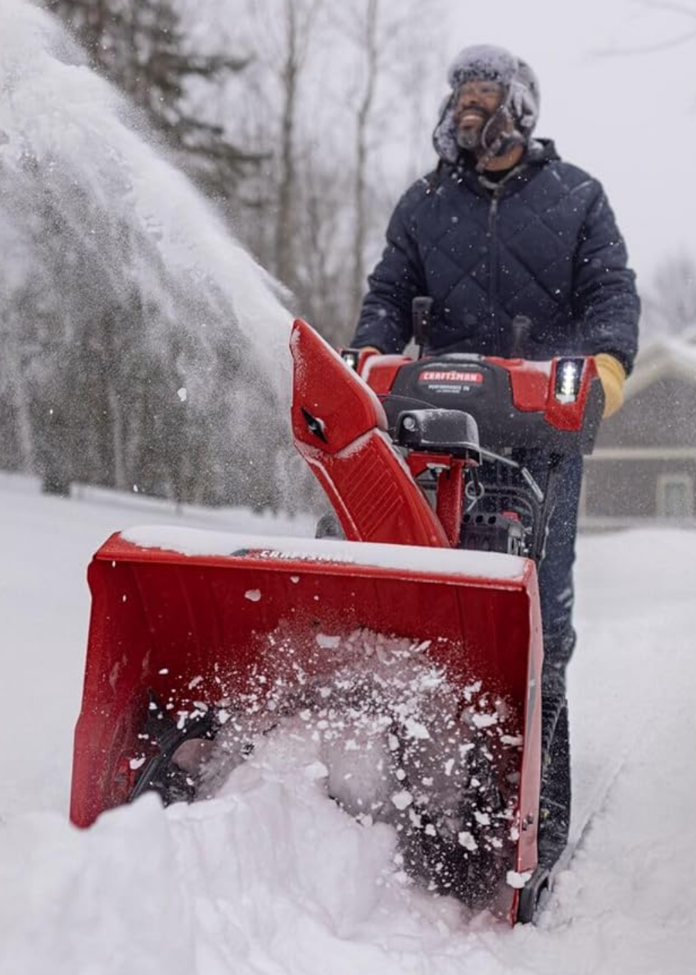 A man blowing snow with a rubber track snow blower for ultimate traction