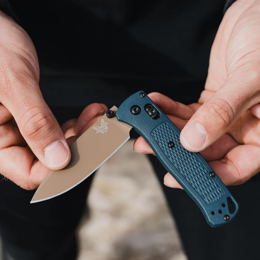 A man holding a Bugout 535 with Cerakote blade.